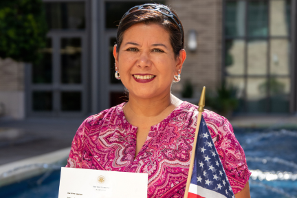 Milu Benko holding an American flag