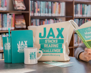 photo of a cup, coffee cup, notebook, and bag