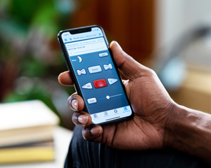 hand holding a mobile device with X-bard