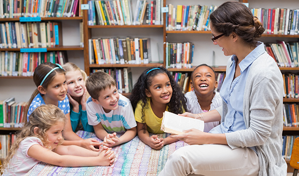 An librarian with children at an afterschool outreach