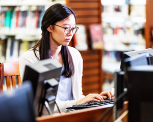 Asian woman using the Public Access Computers at Jacksonville Public Library