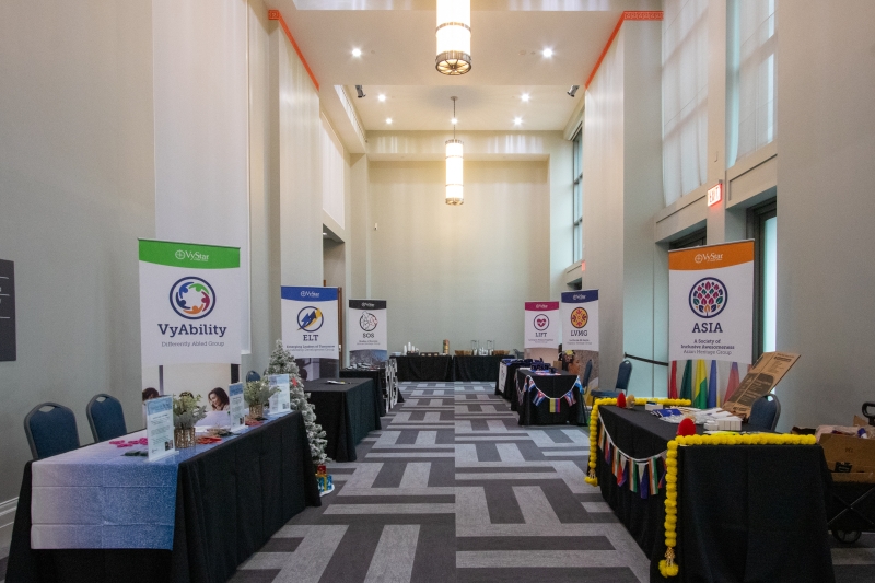 Pre-Function Gallery with vendor tables lined up on both sides of the aisle