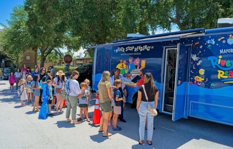 River City Readers Bookmobile with customers waiting in line