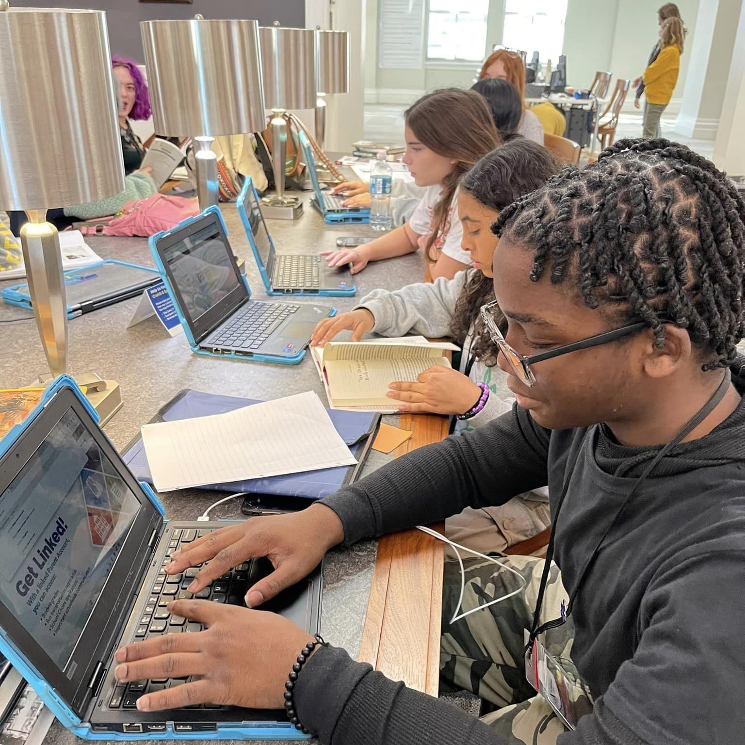 Middle school students using computers to access online databases