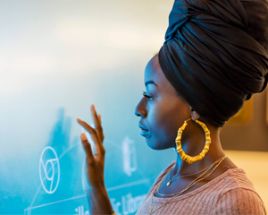 Young woman using new technology learned from a library database
