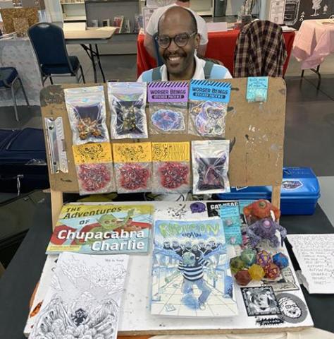 african american male at a table of zines