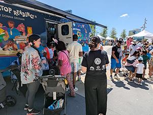 people attend an event with the Bookmobile