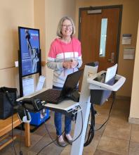 Volunteer Sue is ready to check in customers.