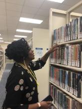 Volunteer Monica shelving books.