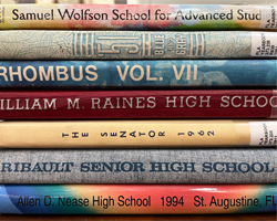 photo of the spines of a stack of yearbooks
